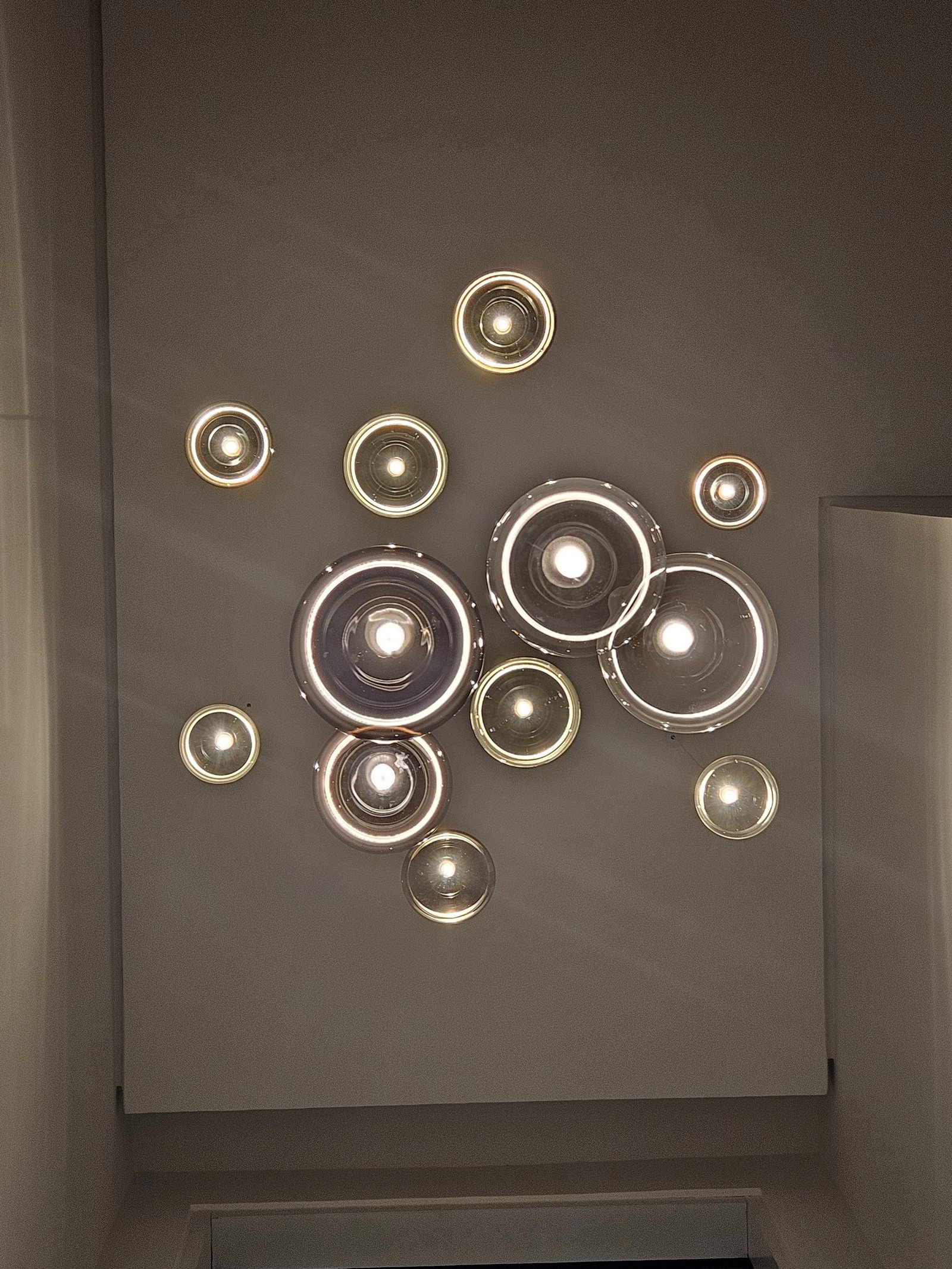 Statement chandelier integrated with architectural lighting